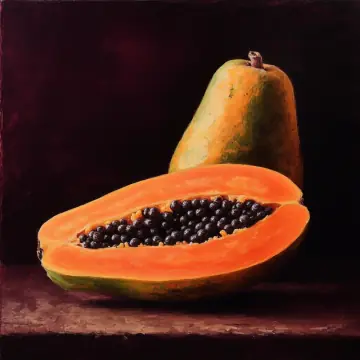 A papaya cut in half, showing its black seeds