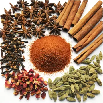 Star anise, cinnamon sticks, cloves and other whole spices around a mound of ground spice