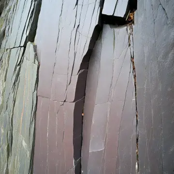 A cracked face of grey slate