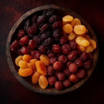 A bowl of dried apricots, raisins and cranberries